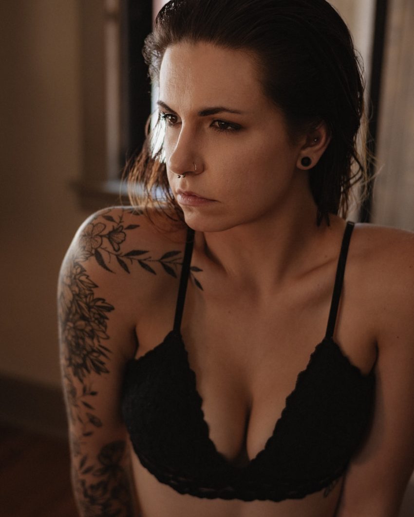 woman in black brassiere with black floral tattoo on her back